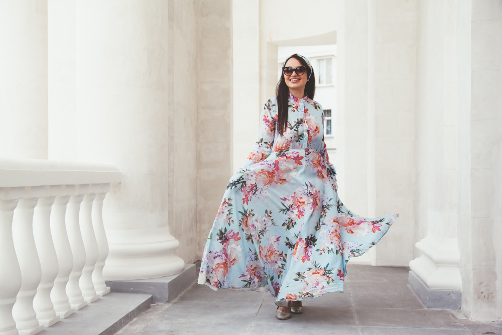 wearing floral maxi dress posing on the city street.