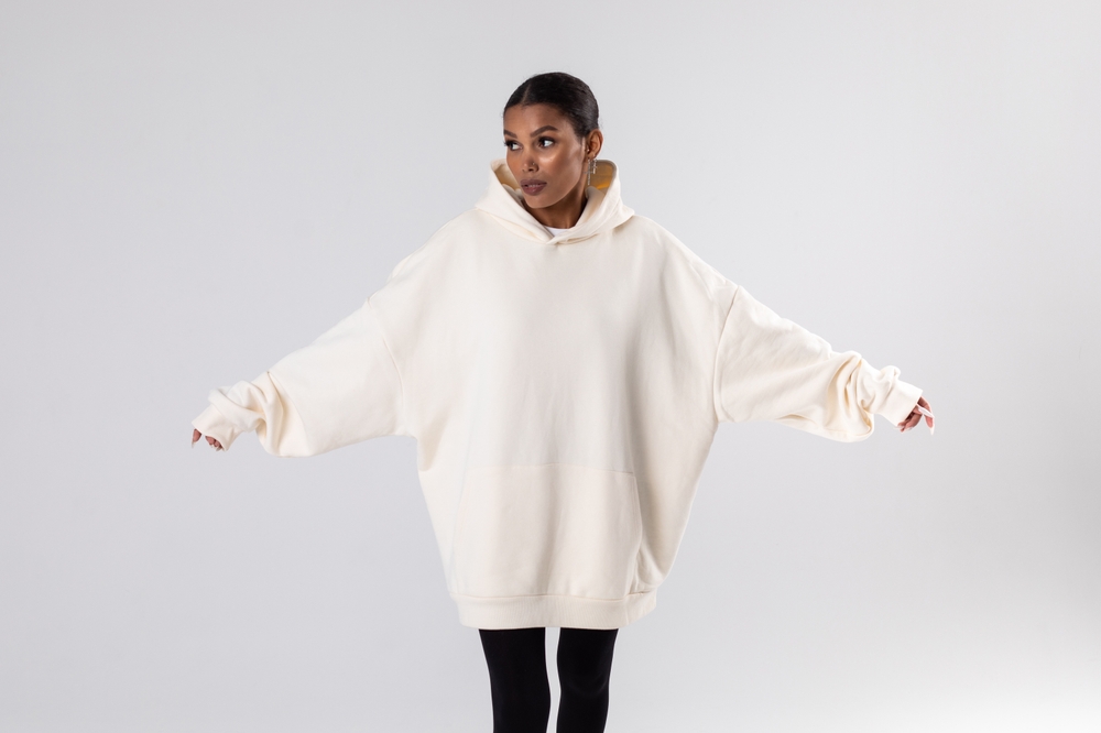 Attractive african american woman in oversized white hoodie. Mock-up.
