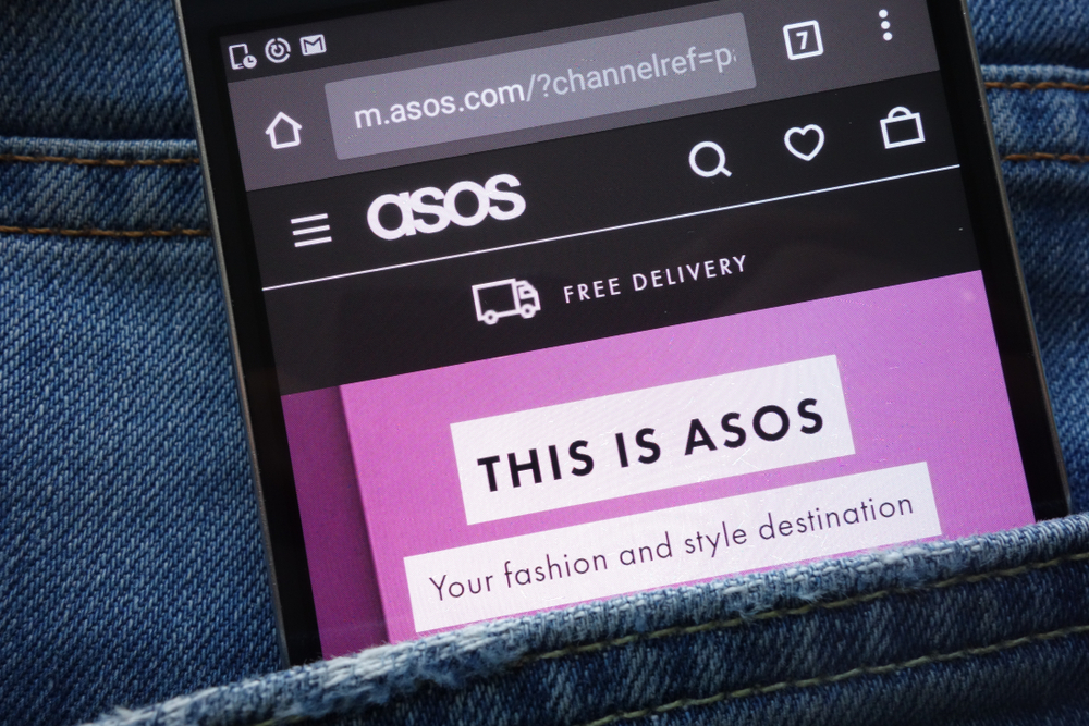 ASOS website displayed on smartphone hidden in jeans pocket