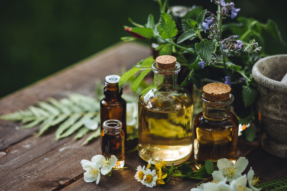 Assortment of organic essential oils, herbal extracts and medical flowers herbs In glass bottles. Alternative therapy, aromatherapy. Natural ingredients in cosmetic and medicine