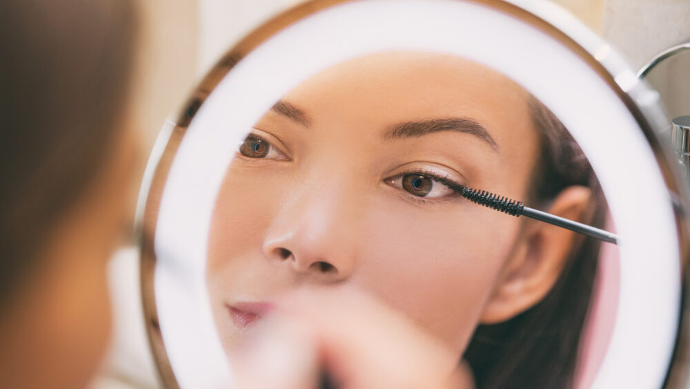 Women doing eye makeup close up with ring light for better view