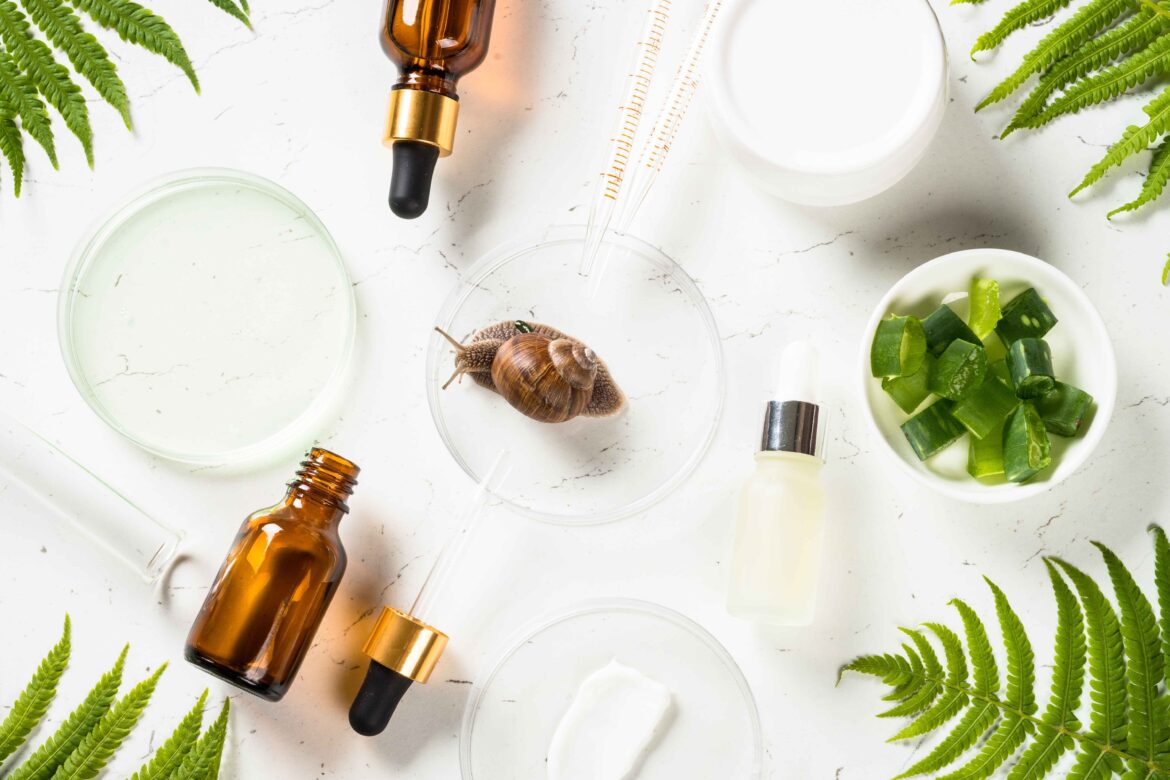 Snail mucin products at white background. Natural anti-aging cosmetic, repair skincare product. Flat lay image.