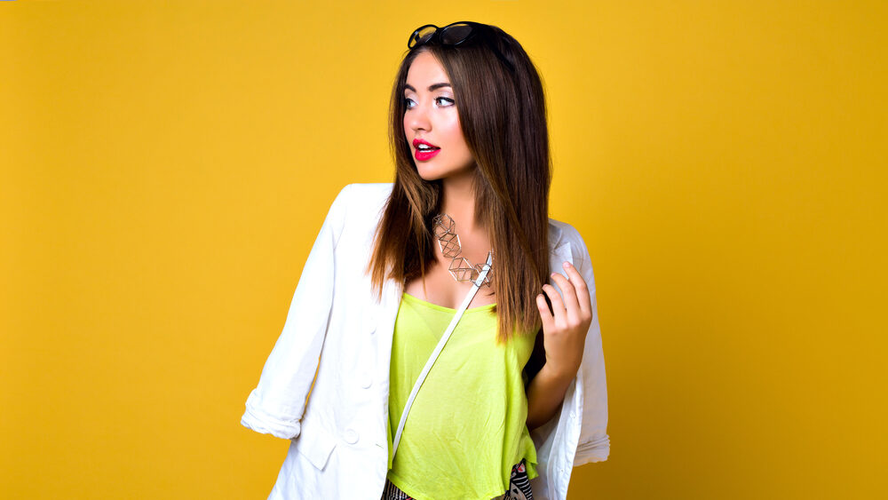 Young woman wearing neon colored top under the blazer